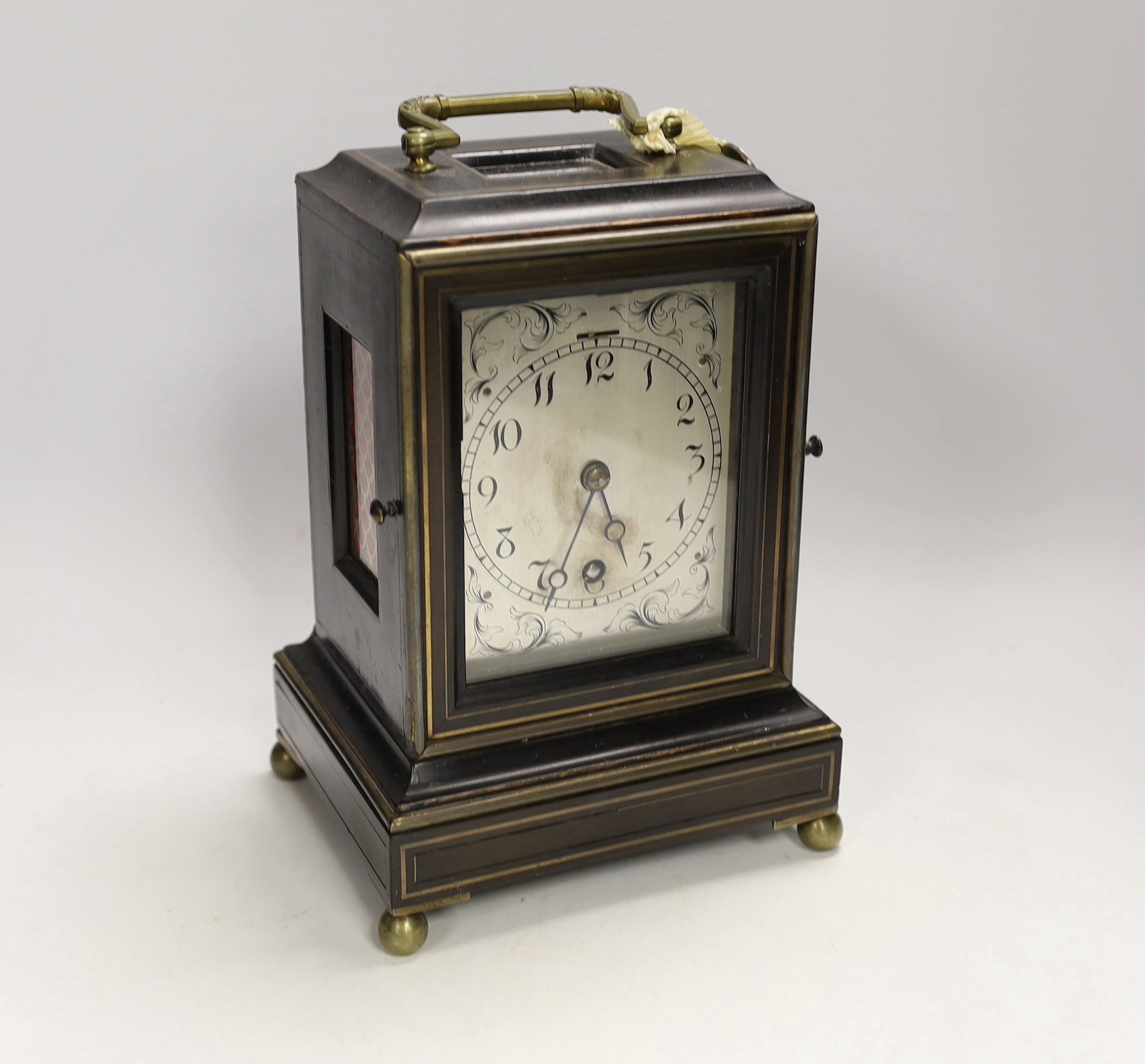 A mantel timepiece with balance escapement, silvered dial and ebonised case, 24cm